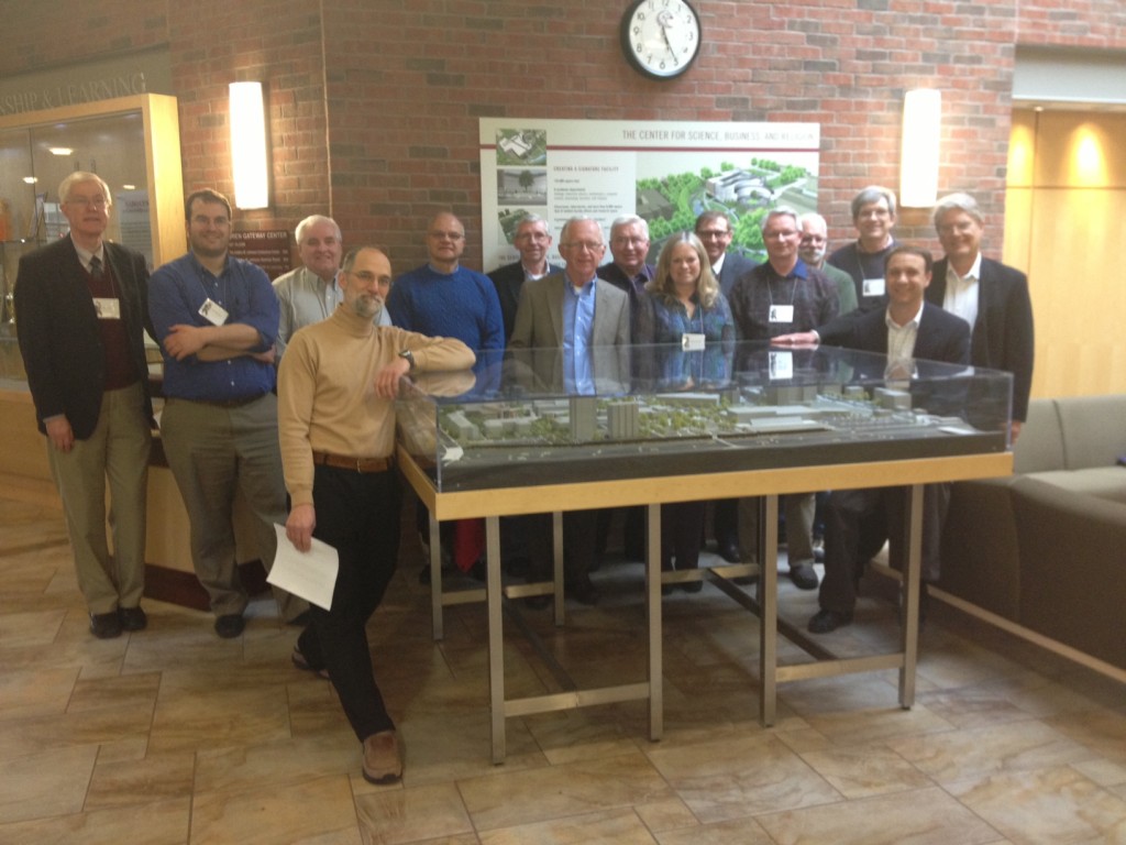 Physics Summit Attendees pose by CSBR model