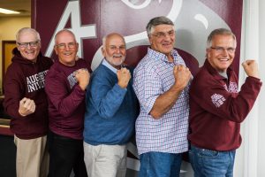 The four friends posing with their arms in gun (L-R Tim Casey, Mike Scott, Bruce Santerre, Larry Stewart and Mike Good)