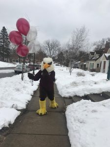 Auggie Eagle holding baloons