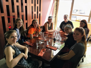 Lizzy sitting at a table with other AYTI participants