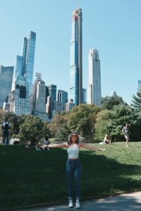 Photo of Grace P standing outside with skyscrapers in the background