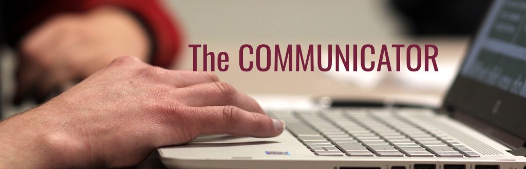 [Image with text] Sideview of a hand working a laptop. "The Communicator" appears over the image