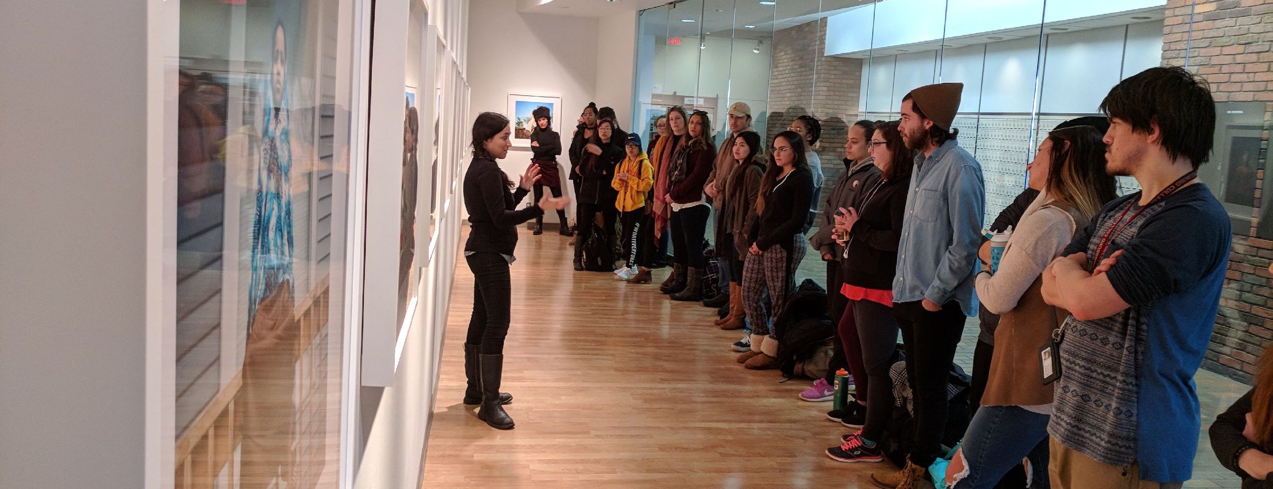 Student listening to a speaker in an art gallery