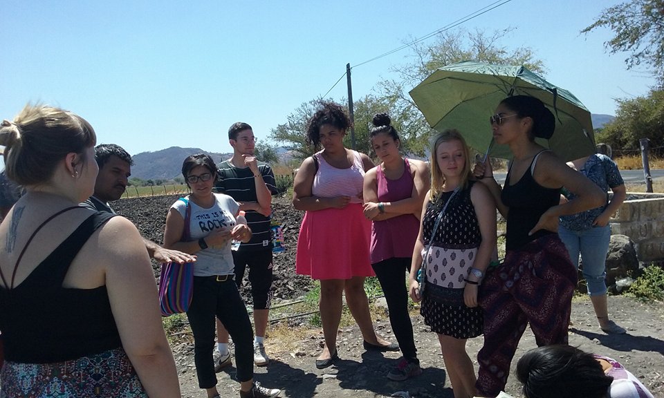 Students listen to a lecture outdoors