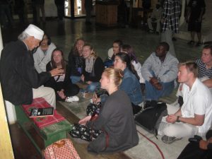 student group on floor listens to speaker