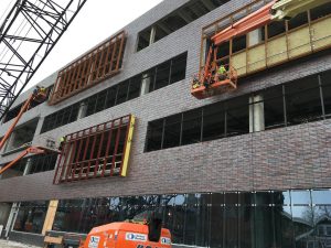 Construction crews continue installation of window frames on the east side of the north wing. 