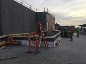 The base of the rooftop greenhouse is under construction.