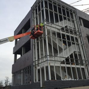 Crews prepare the steel structure on the west staircase to support installation of the glass curtainwall.