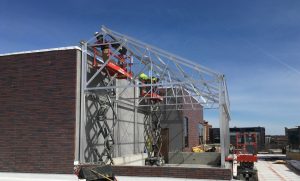 Crews install the structural aluminum framework for the rooftop greenhouse.