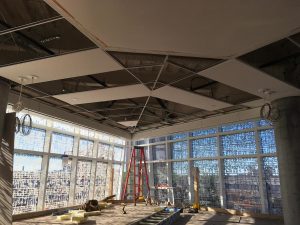 Ceiling grid and tile installation in progress in the lobby