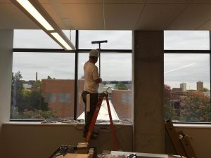 A crew member cleans a window