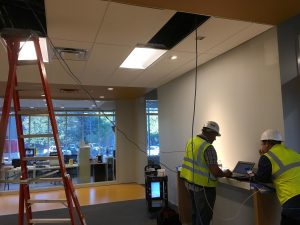 Crew members using machines to set the HVAC system