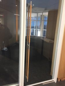 Glass door with wooden dowel handles