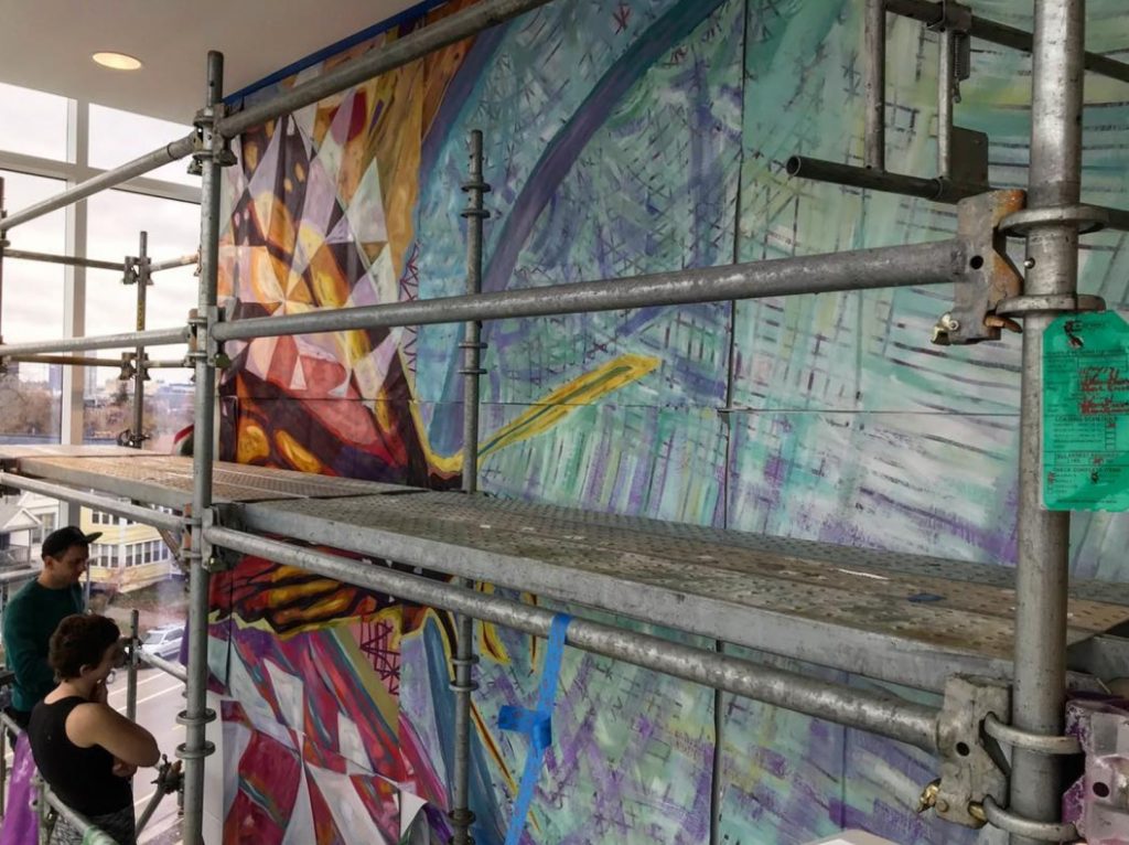 Colorful mural with scaffolding in front