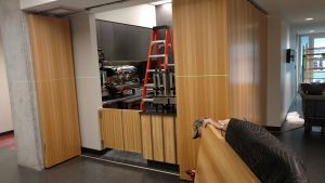 Crew member prepares a door panel for hanging