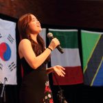 international student singing at banquet