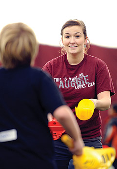 Augsburg students plays with a elementary school aged student