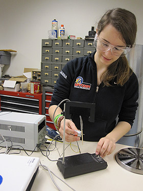 Taylor McCanna works in the Augsburg College labs. She developed six prototypes of a field mill before creating a device that could measure the global electric circuit.