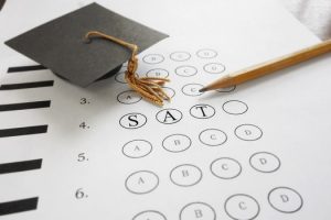 SAT test bubble sheet with a graduation cap and pencil 