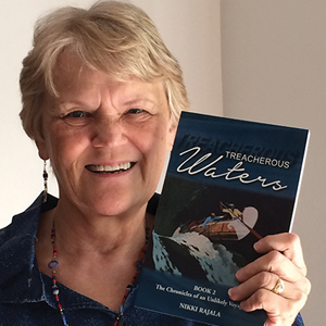 Nikki Pajala holding her book "Treacherous Waters"