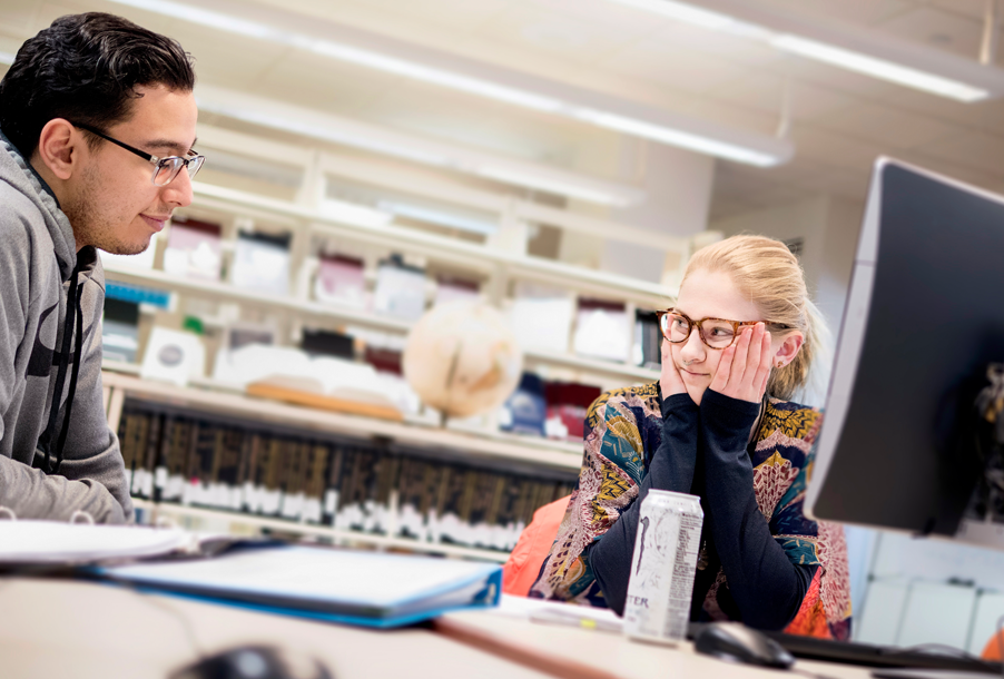 Joaquin Delgado-Ortiz, left, and Ann Sheely working in the library