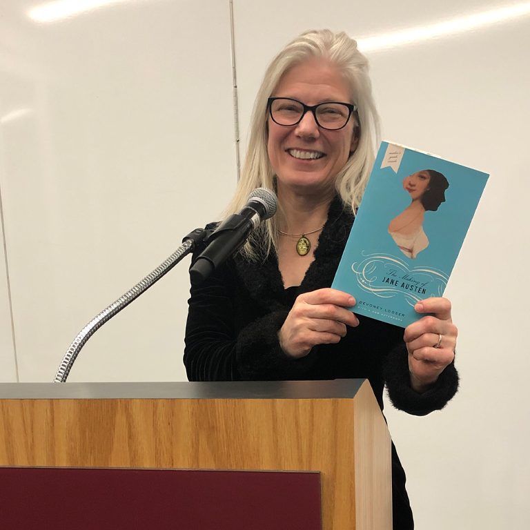 Devaney holding up her book “The Making of Jane Austen.”