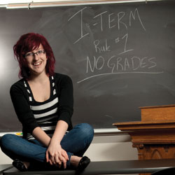 Augsburg student sits near a chalkboard